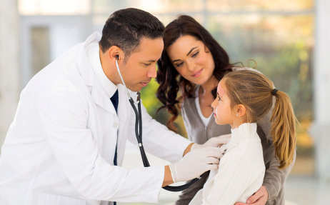 male doctor examining a cute girl